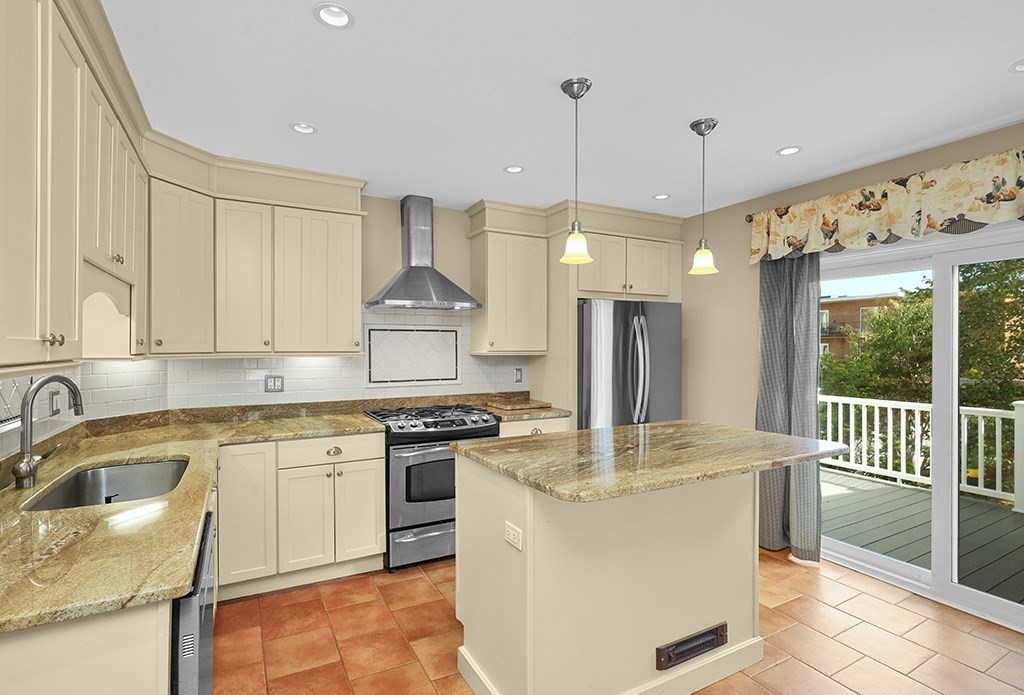 339 Winthrop Street Winthrop, MA 02152 - Photo 8 of 42 a kitchen with a sink a stove a refrigerator and black cabinets