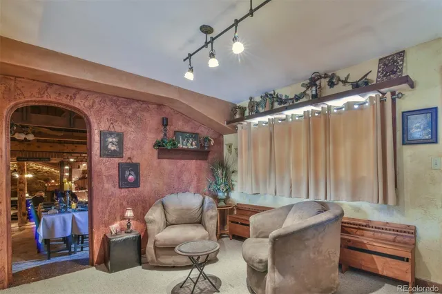 a living room with furniture and a chandelier