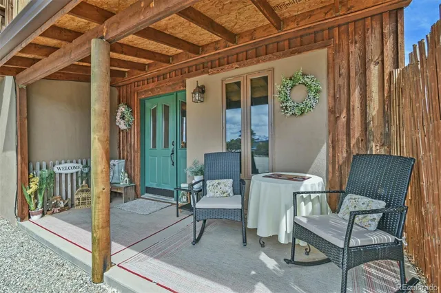 a view of a porch with a table and chairs
