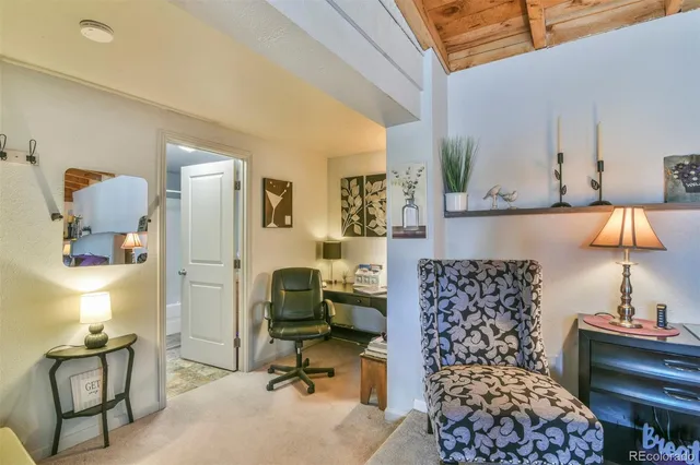 a bedroom with furniture and a lamp