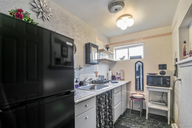 a kitchen with stainless steel appliances a sink stove and refrigerator