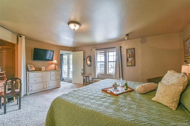 a bed room with furniture and a flat screen tv