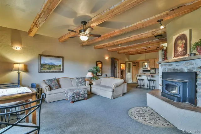 a living room with furniture a fireplace and a chandelier