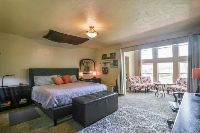 a bedroom with a large bed and a large window