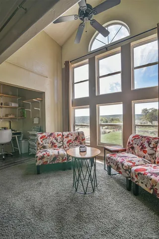 a bedroom with furniture and a large window