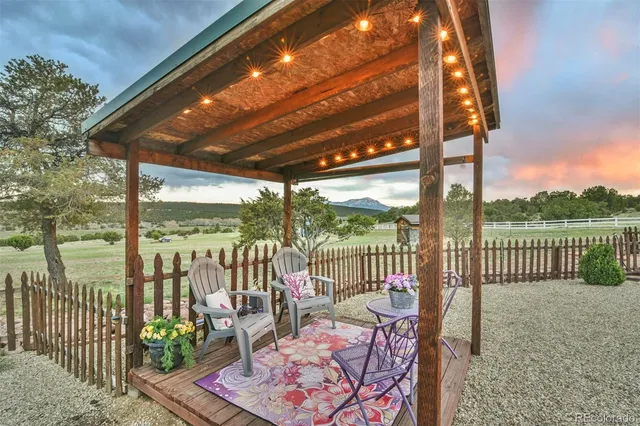 a view of a chair and tables in the balcony