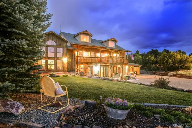 a view of a house with backyard and sitting area