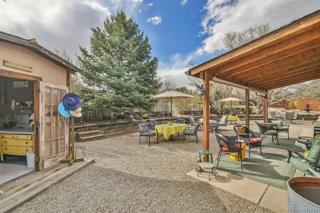 a view of a patio with a table and chairs