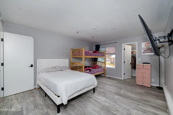 a bedroom with a bed and a desk