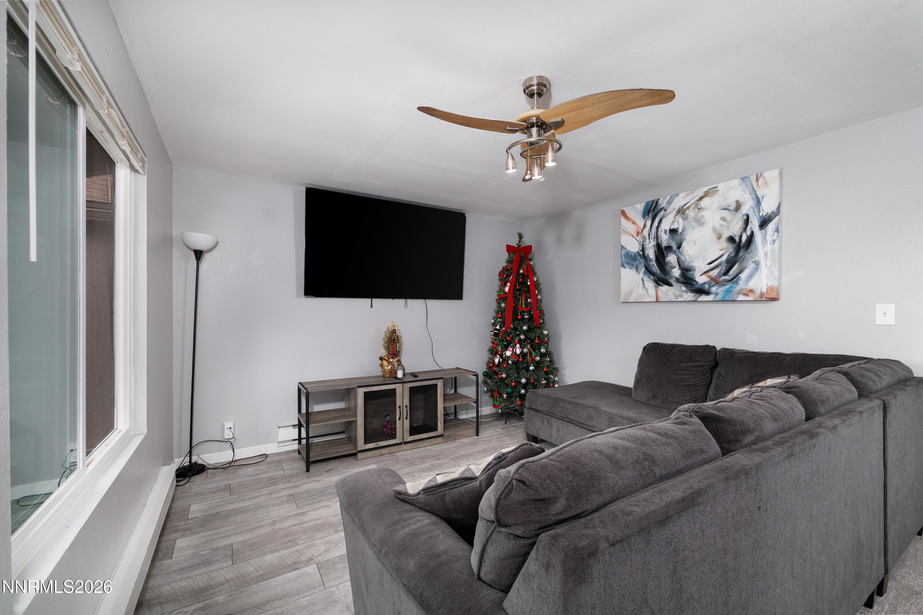 3935 Clear Acre Lane, Unit 214 Reno, NV 89512 - Photo 8 of 15 a living room with furniture and a flat screen tv