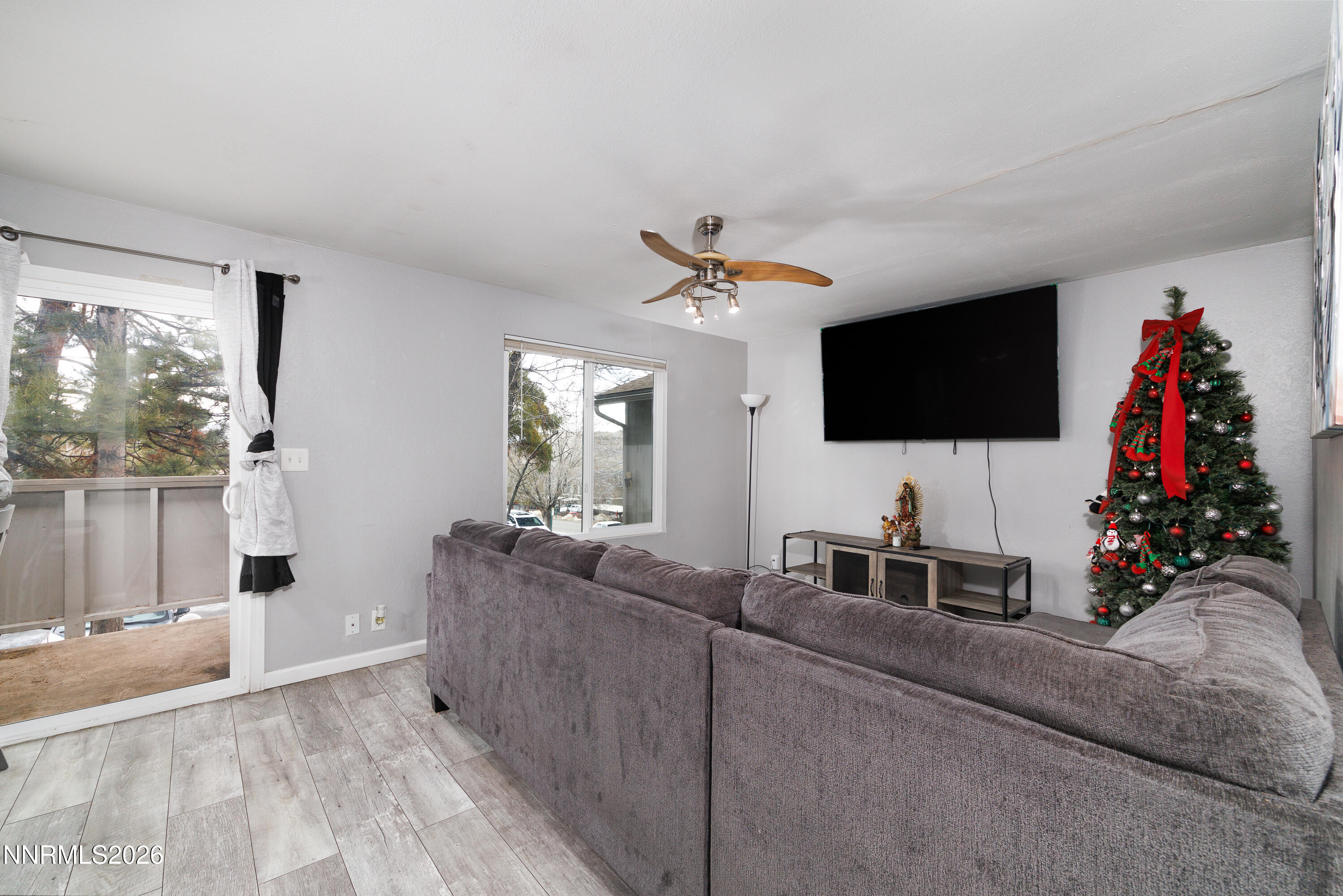 3935 Clear Acre Lane, Unit 214 Reno, NV 89512 - Photo 9 of 15 a living room with furniture and a flat screen tv