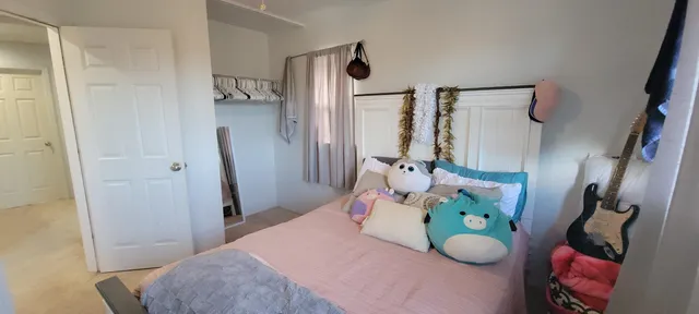 a bedroom with a bed and a window