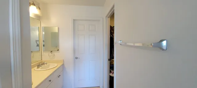 a bathroom with a granite countertop sink a toilet and shower