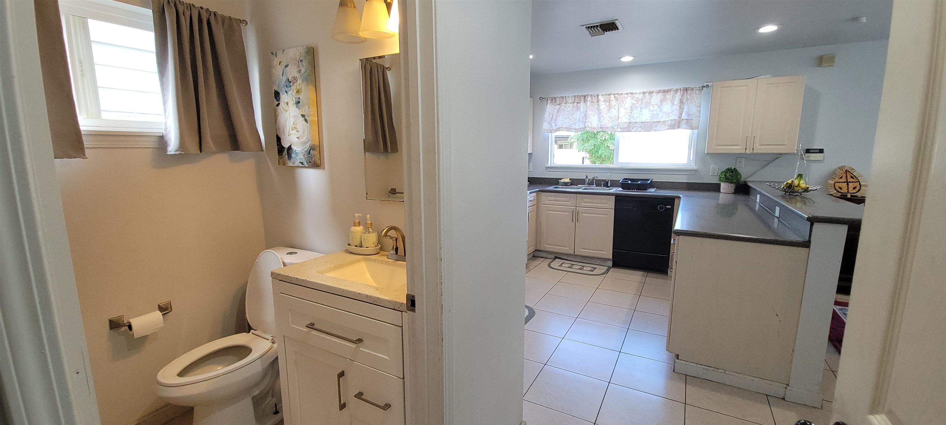 10 West Makahehi Loop Kahului, HI 96732 - Photo 5 of 18 a bathroom with a granite countertop toilet sink and mirror