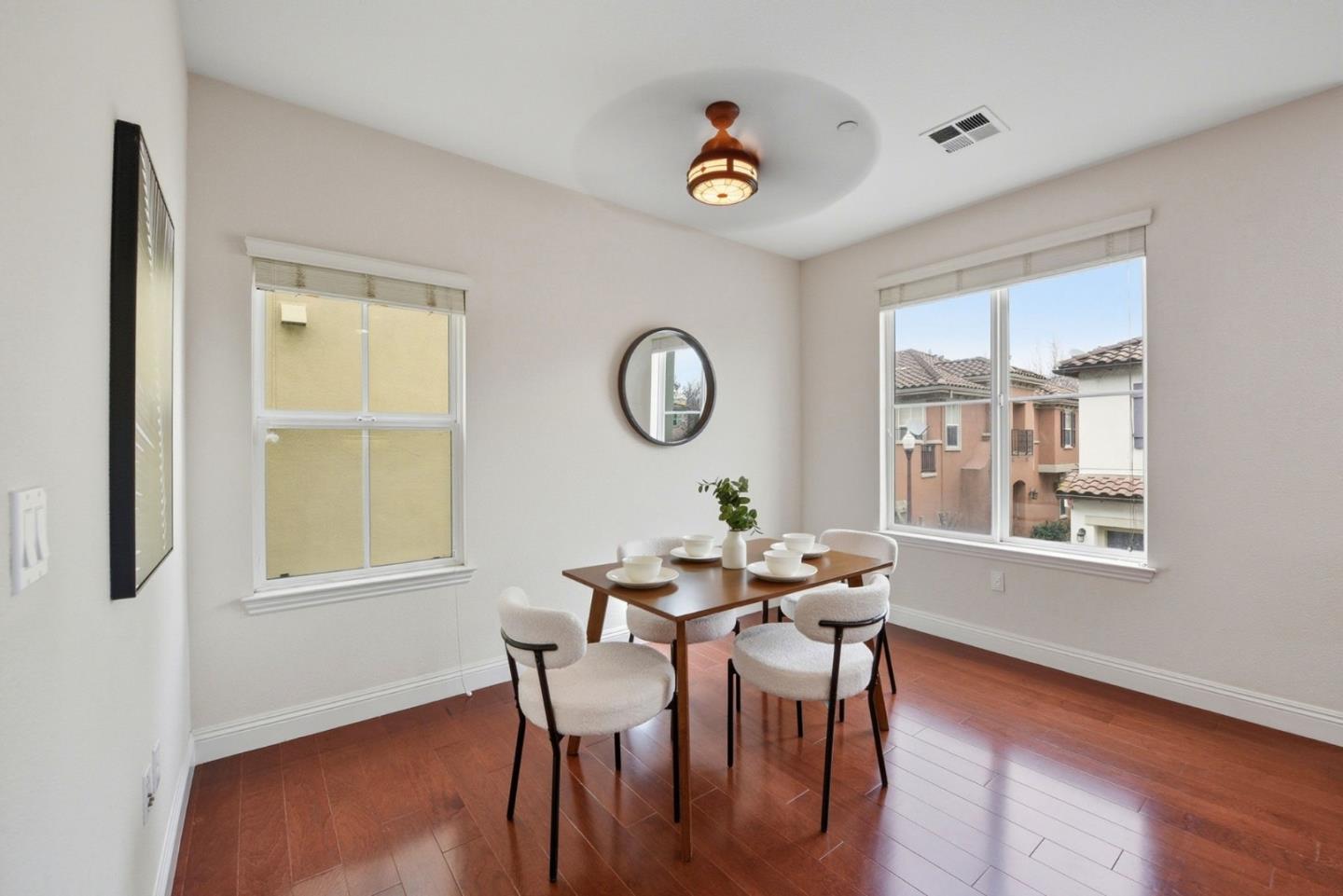 48962 Woodgrove Common Fremont, CA 94539 - Photo 11 of 36 a view of a dining room with furniture window and wooden floor