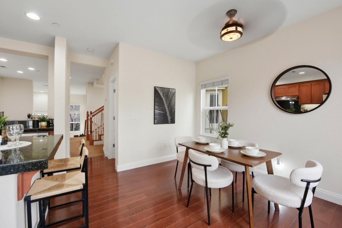 48962 Woodgrove Common Fremont, CA 94539 - Photo 12 of 36 a view of a dining room with furniture and wooden floor