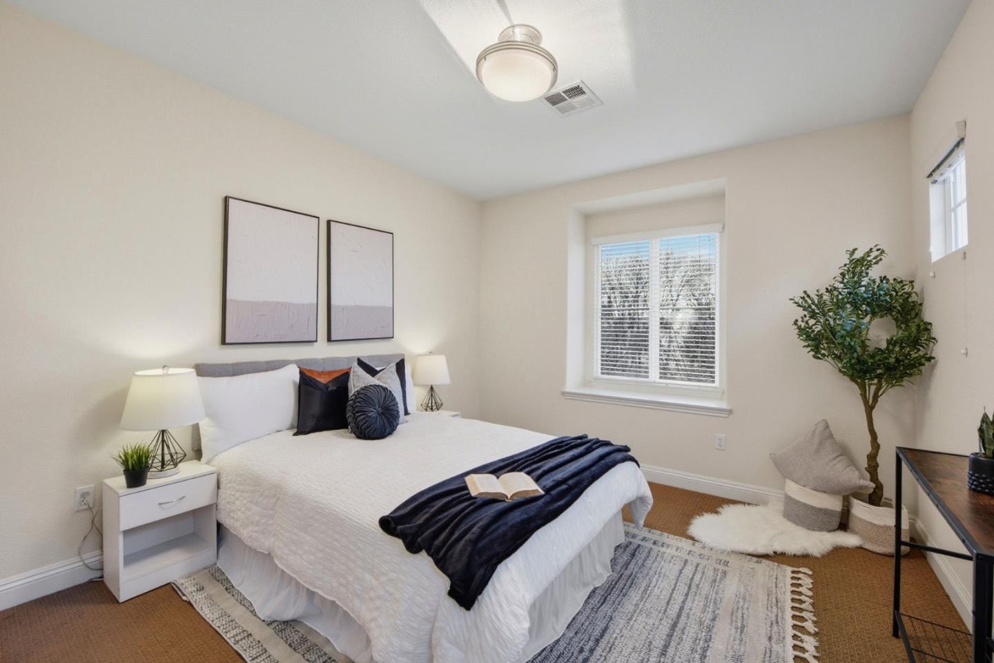 48962 Woodgrove Common Fremont, CA 94539 - Photo 13 of 36 a bedroom with a bed and a potted plant