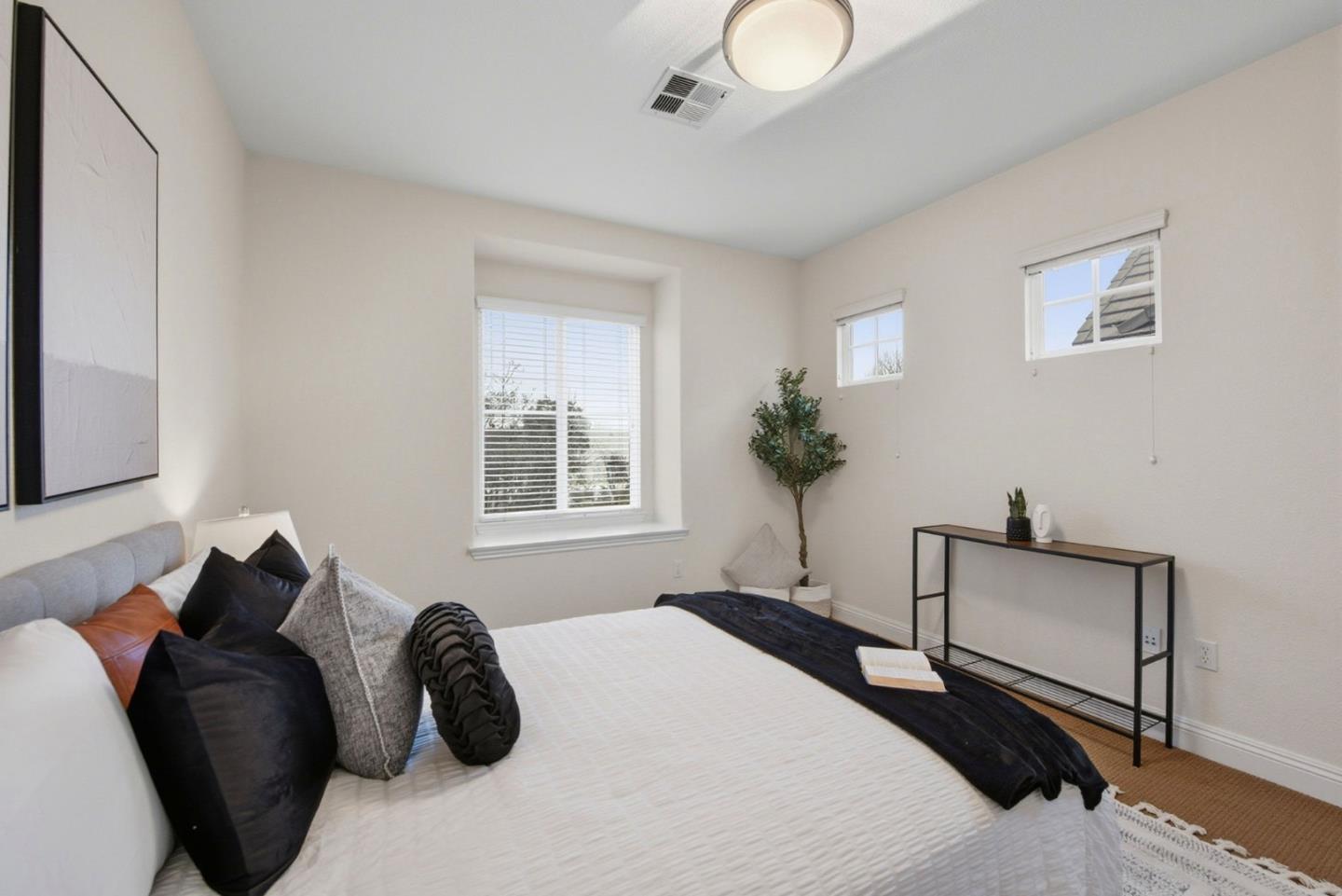 48962 Woodgrove Common Fremont, CA 94539 - Photo 14 of 36 a bedroom with a bed and a potted plant