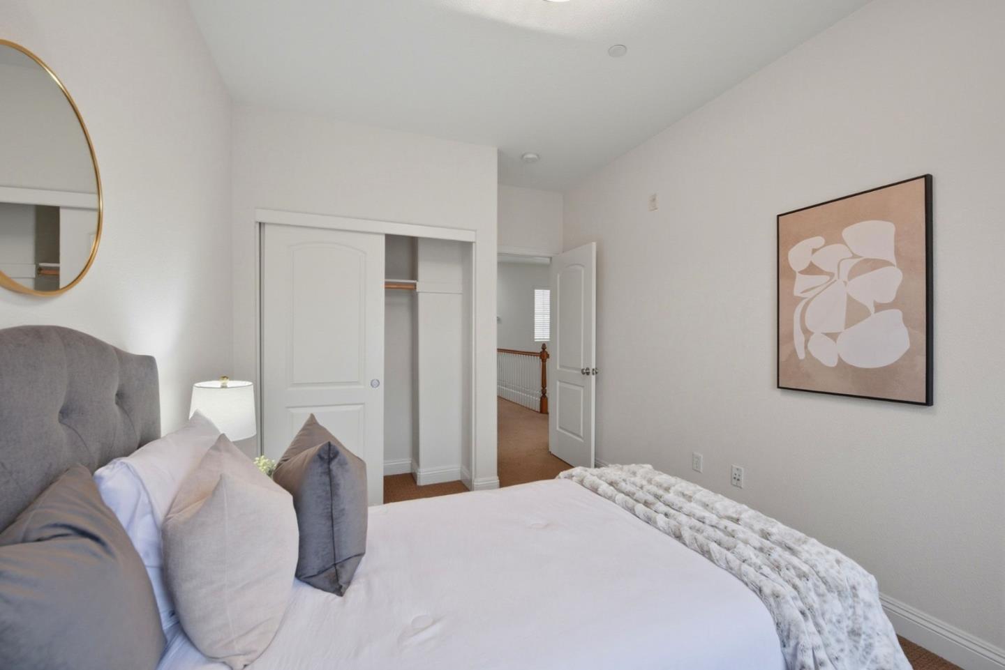 48962 Woodgrove Common Fremont, CA 94539 - Photo 16 of 36 a bedroom with a bed and a painting on the wall