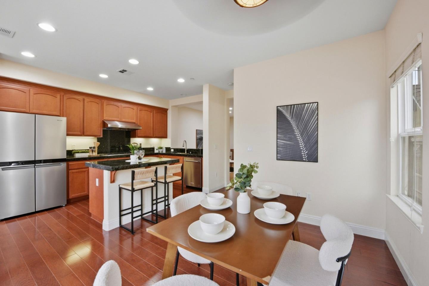 48962 Woodgrove Common Fremont, CA 94539 - Photo 5 of 36 a kitchen with stainless steel appliances granite countertop a dining table and chairs