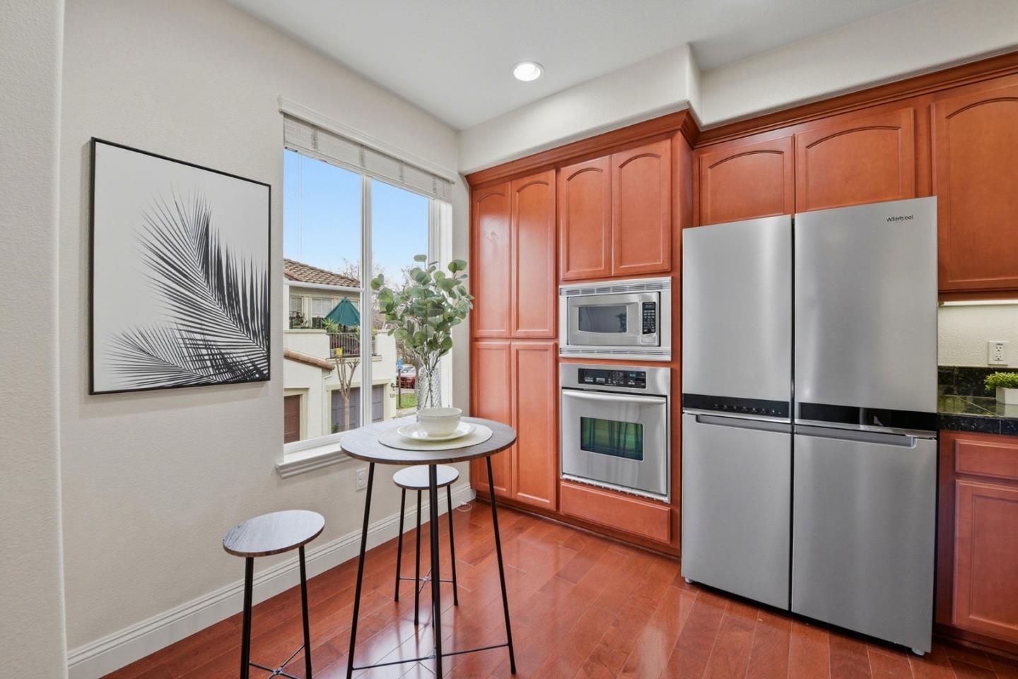 48962 Woodgrove Common Fremont, CA 94539 - Photo 6 of 36 a kitchen with stainless steel appliances a refrigerator and a stove top oven