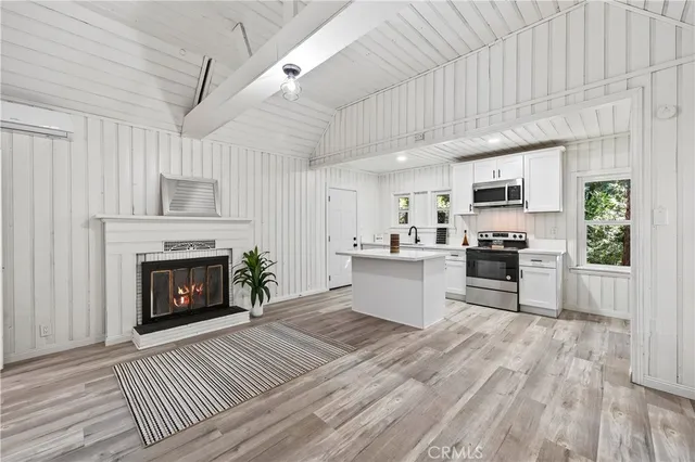 a kitchen with a refrigerator and a stove top oven