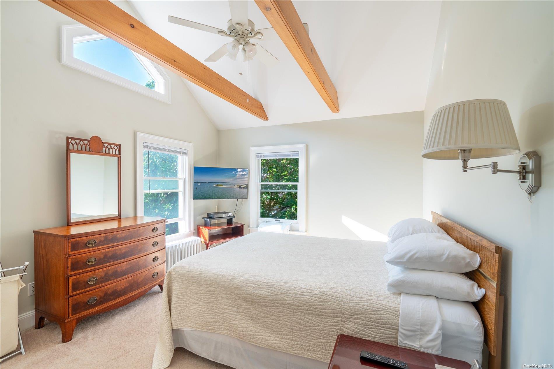 231 5th Avenue Greenport, NY 11944 - Photo 11 of 18 a bedroom with a bed and wooden floor