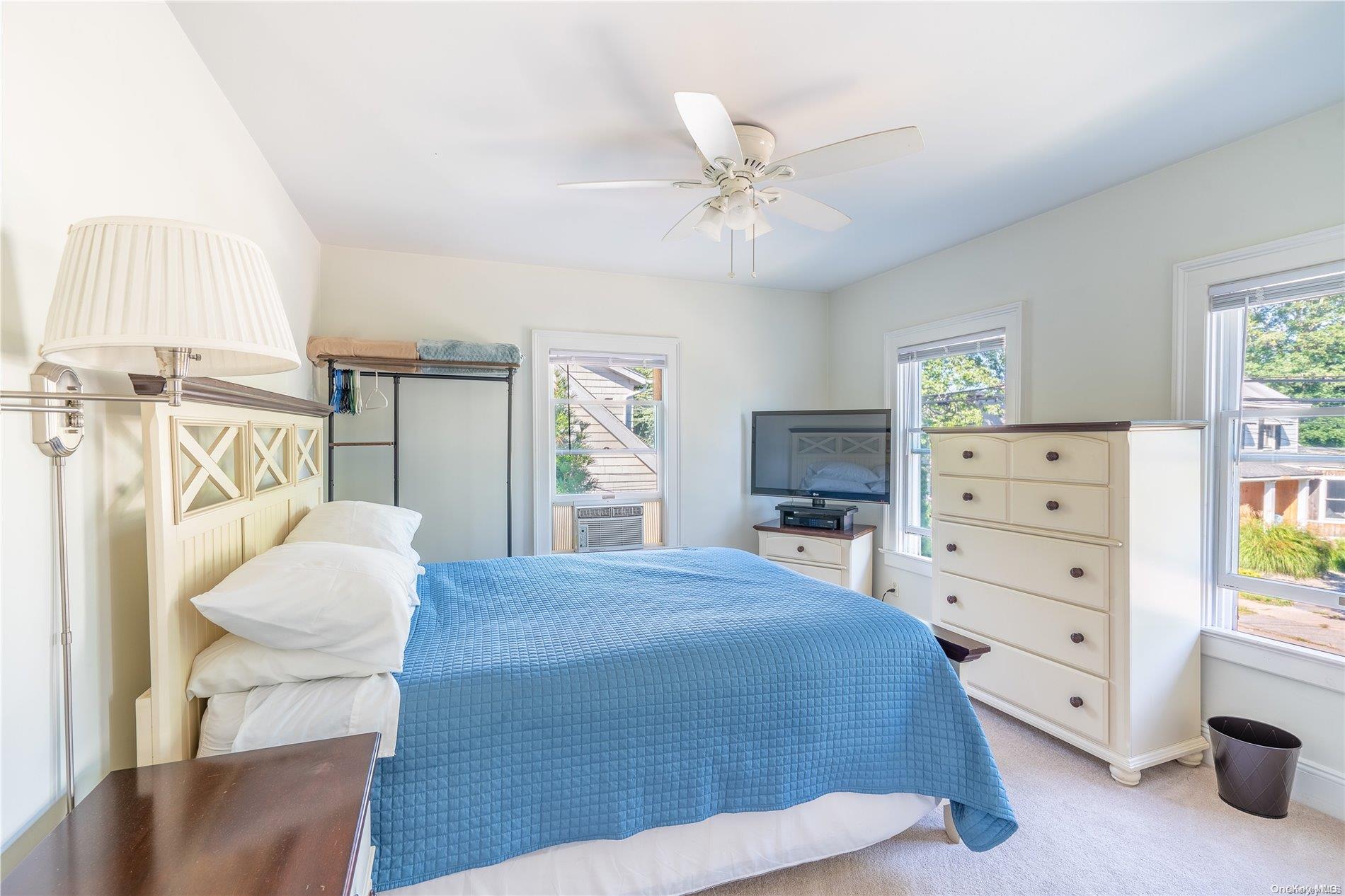 231 5th Avenue Greenport, NY 11944 - Photo 13 of 18 a bedroom with a bed and a dresser