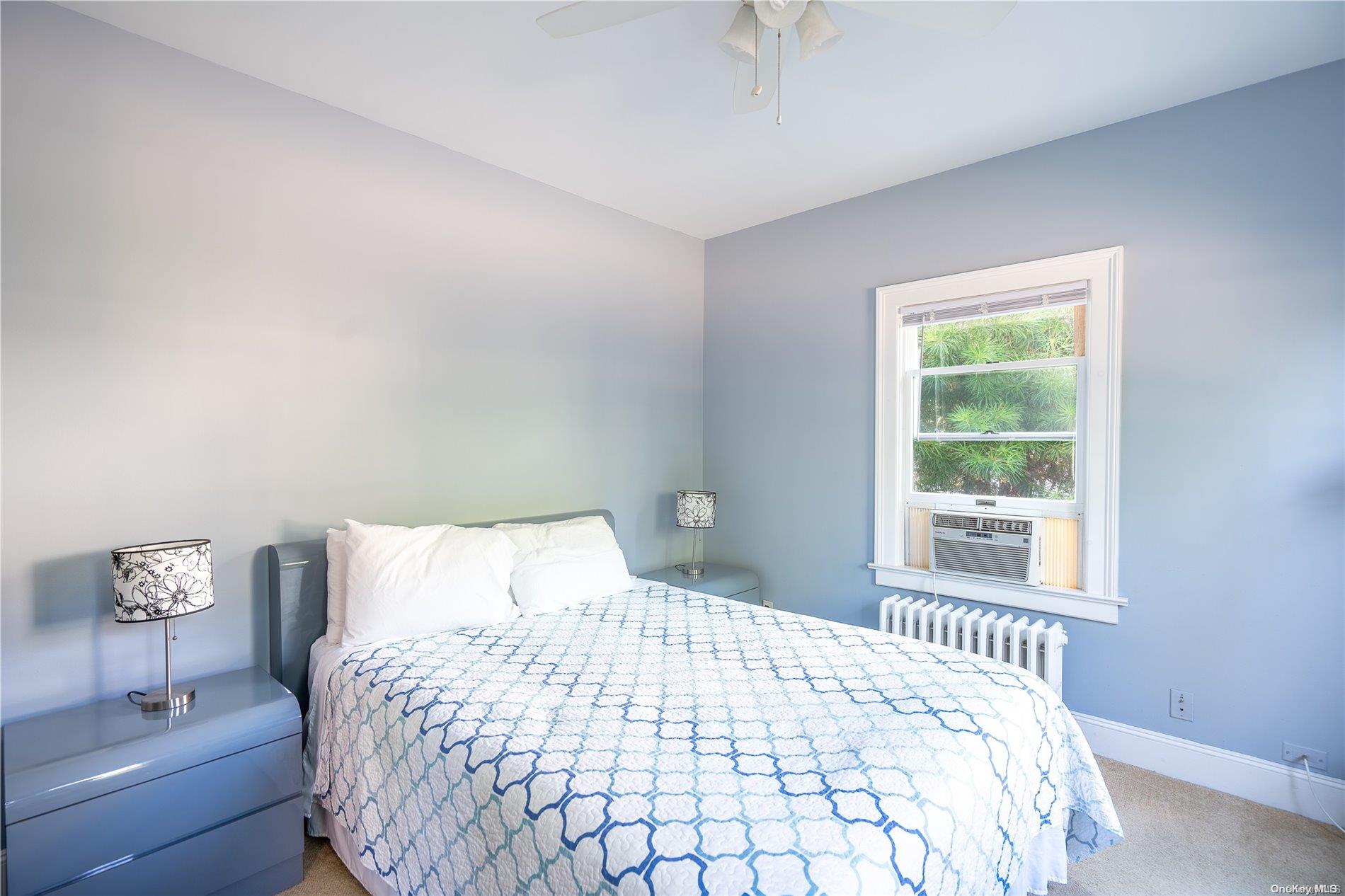 231 5th Avenue Greenport, NY 11944 - Photo 14 of 18 a bedroom with a bed and a window