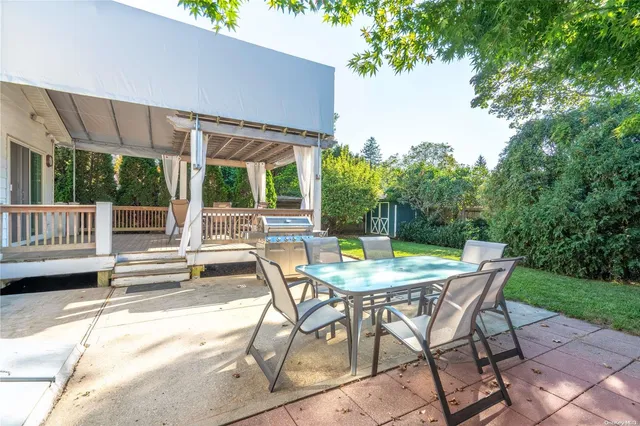 a view of a patio with a table chairs and a table