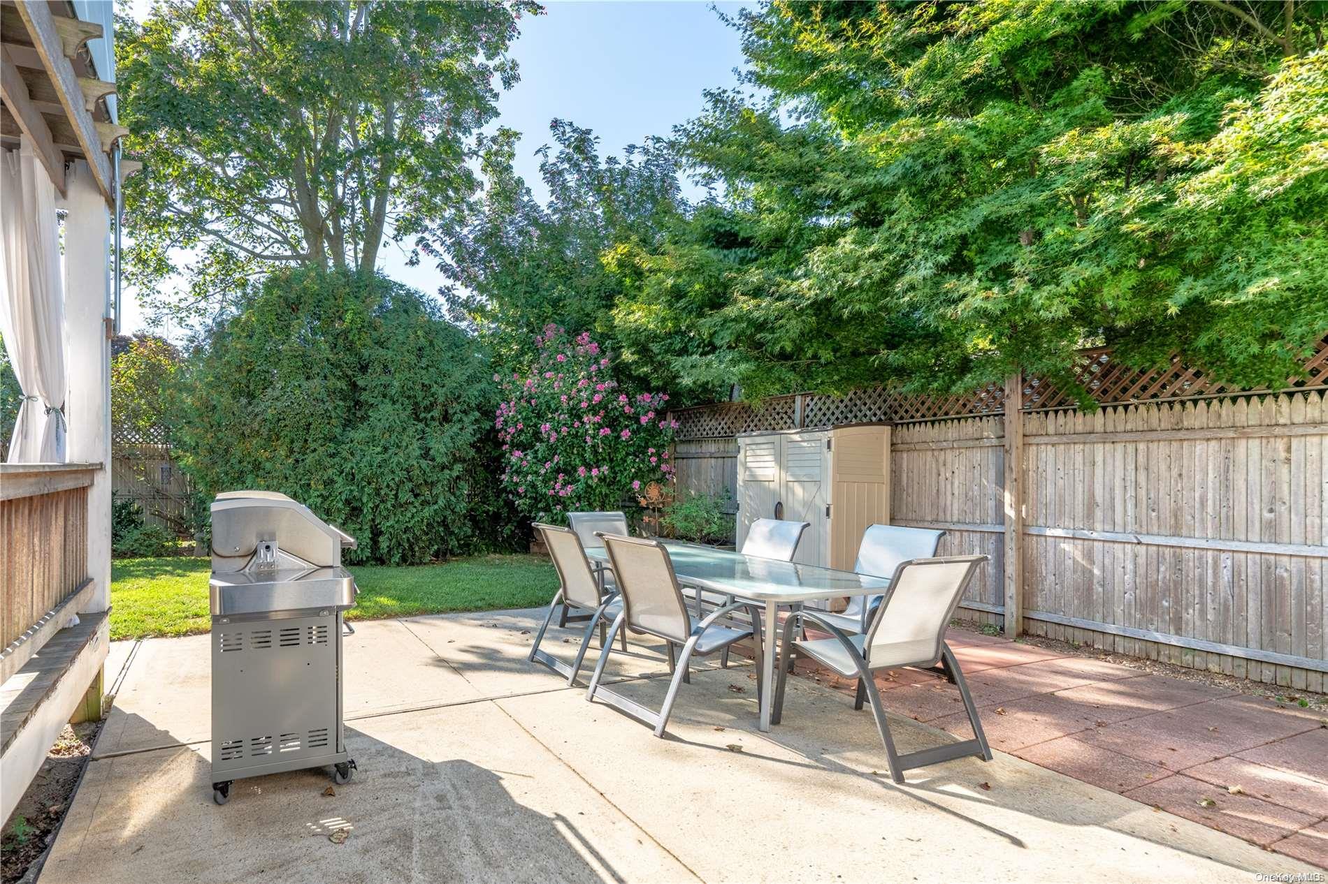 231 5th Avenue Greenport, NY 11944 - Photo 5 of 18 a view of a chairs and table in the back yard of the house