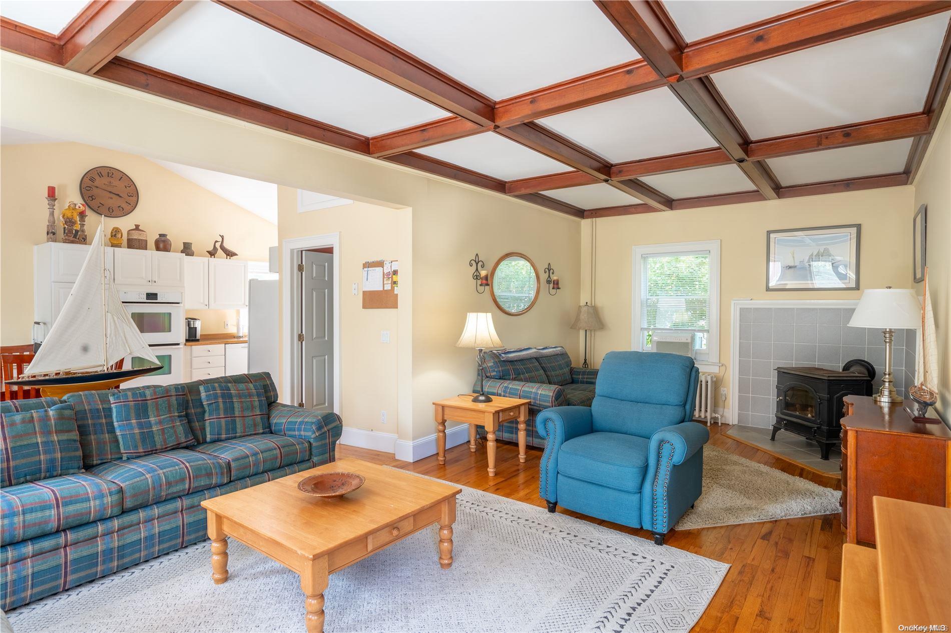 231 5th Avenue Greenport, NY 11944 - Photo 7 of 18 a living room with furniture and a large window