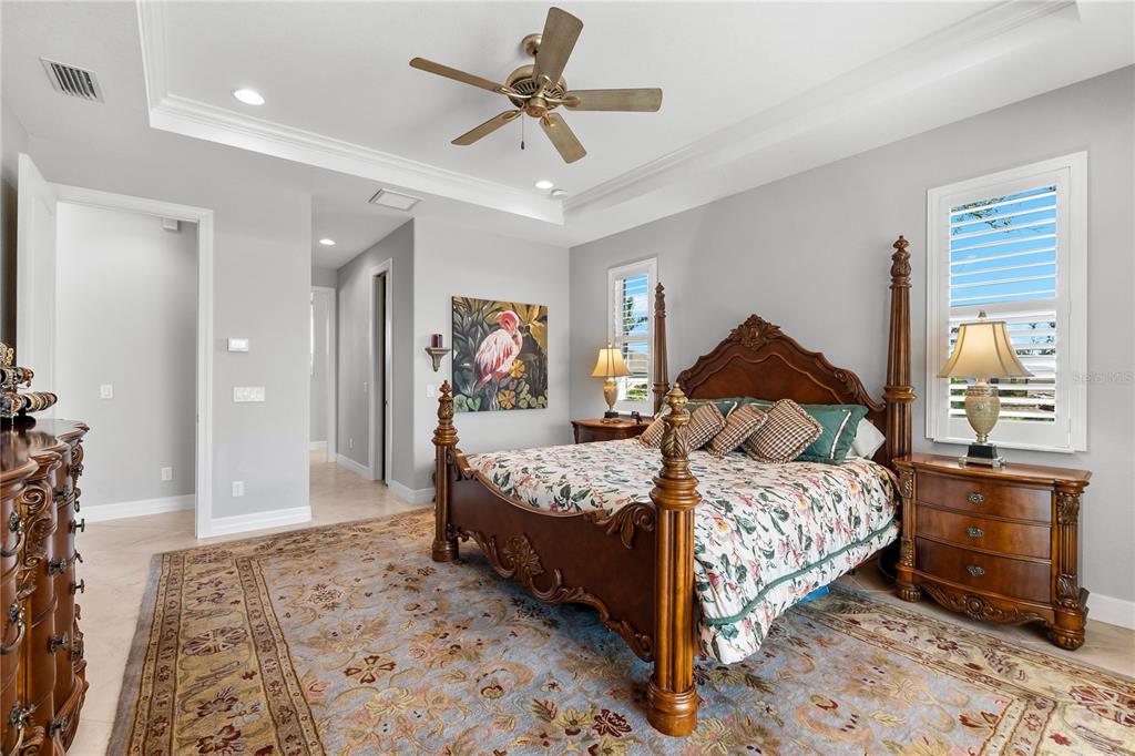 10491 Sarasota Road Port Charlotte, FL 33981 - Photo 16 of 44 a bedroom with a bed and wooden floor