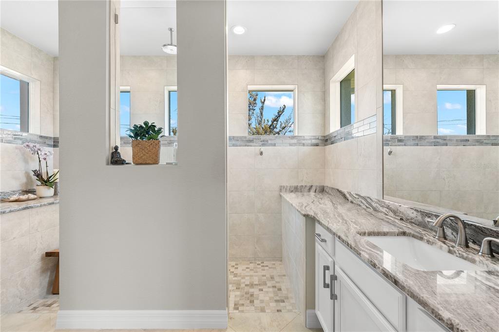 10491 Sarasota Road Port Charlotte, FL 33981 - Photo 17 of 44 a bathroom with a granite countertop sink and a mirror