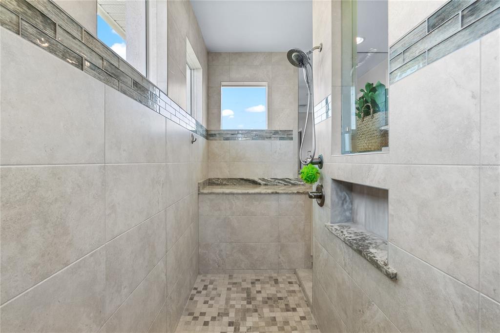 10491 Sarasota Road Port Charlotte, FL 33981 - Photo 20 of 44 a bathroom with a granite countertop shower a sink and a mirror
