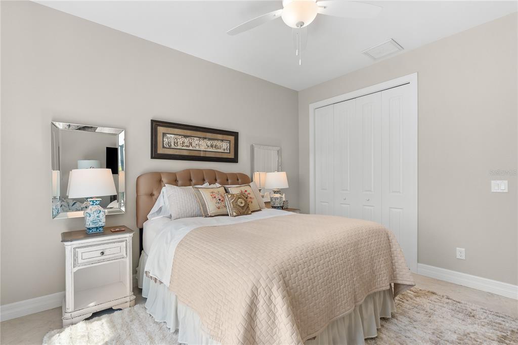 10491 Sarasota Road Port Charlotte, FL 33981 - Photo 25 of 44 a bedroom with a bed and a lamp