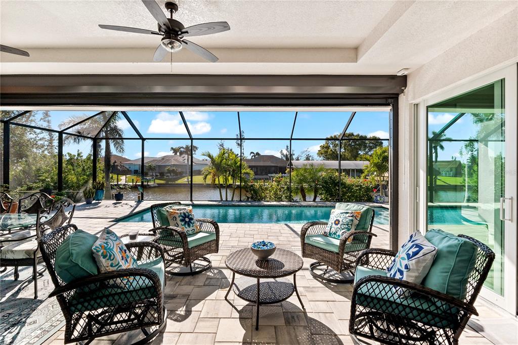 10491 Sarasota Road Port Charlotte, FL 33981 - Photo 26 of 44 a living room with patio furniture and a floor to ceiling window