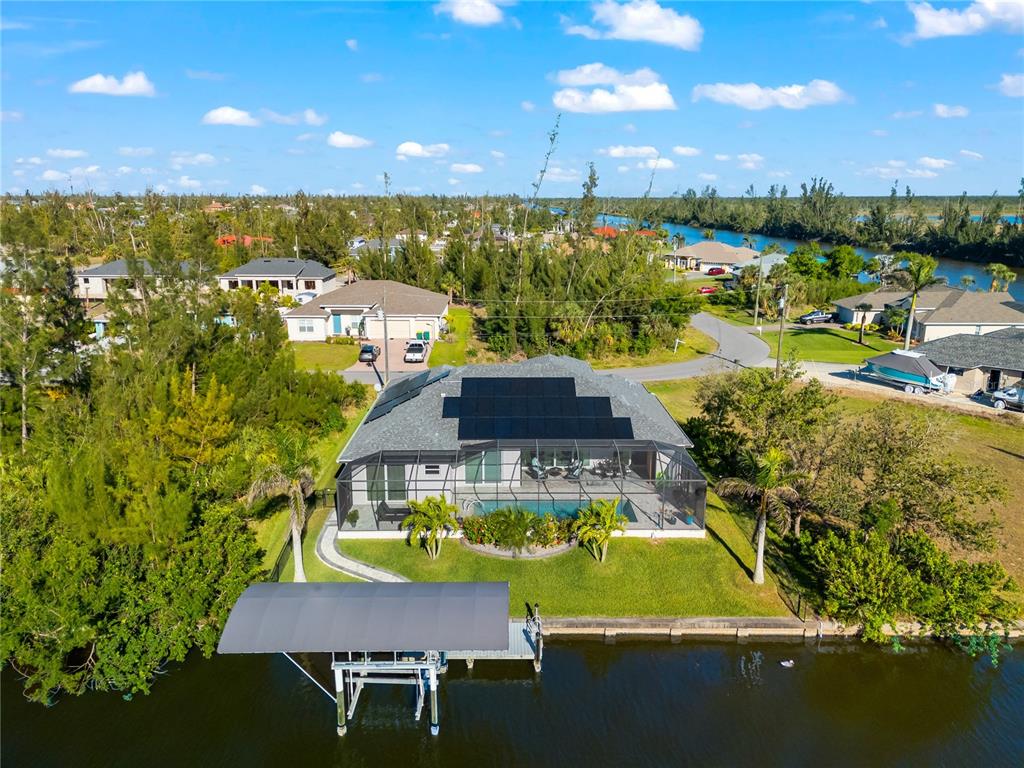 10491 Sarasota Road Port Charlotte, FL 33981 - Photo 43 of 44 a view of a swimming pool with lawn chairs under an umbrella