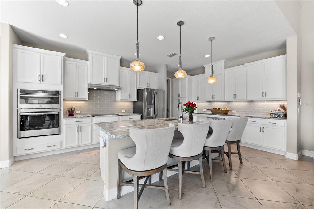 10491 Sarasota Road Port Charlotte, FL 33981 - Photo 10 of 44 a kitchen with stainless steel appliances a dining table chairs and sink