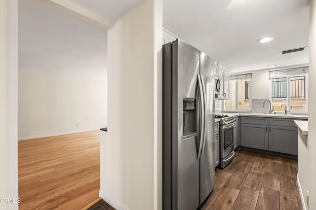 a kitchen with a refrigerator and a sink