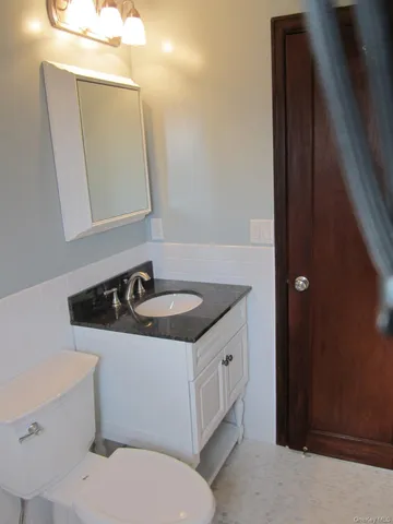 a bathroom with a sink toilet and mirror