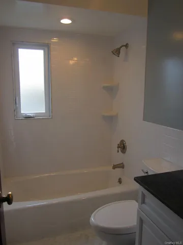 a bathroom with a toilet a sink and bathtub