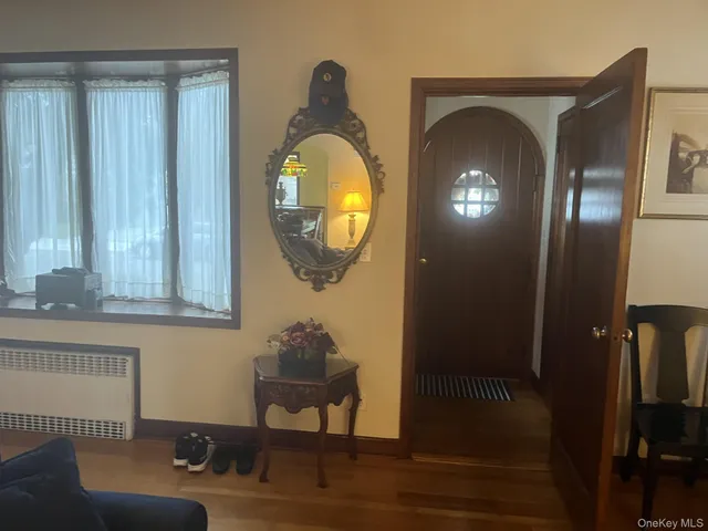 a living room with furniture and a mirror