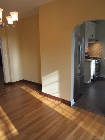 a kitchen with a refrigerator and a stove top oven