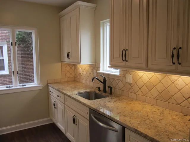 a kitchen with a sink and cabinets
