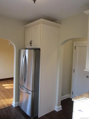 a metallic refrigerator freezer sitting in a kitchen