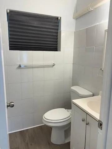 a bathroom with a toilet a sink and shower