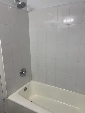 a white bath tub and shower