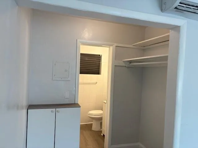 a bathroom with a granite countertop toilet and a sink