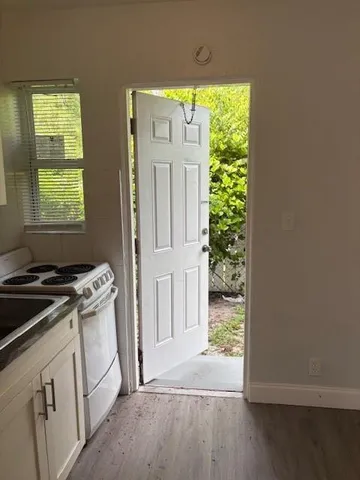 a kitchen with white cabinets and a stove